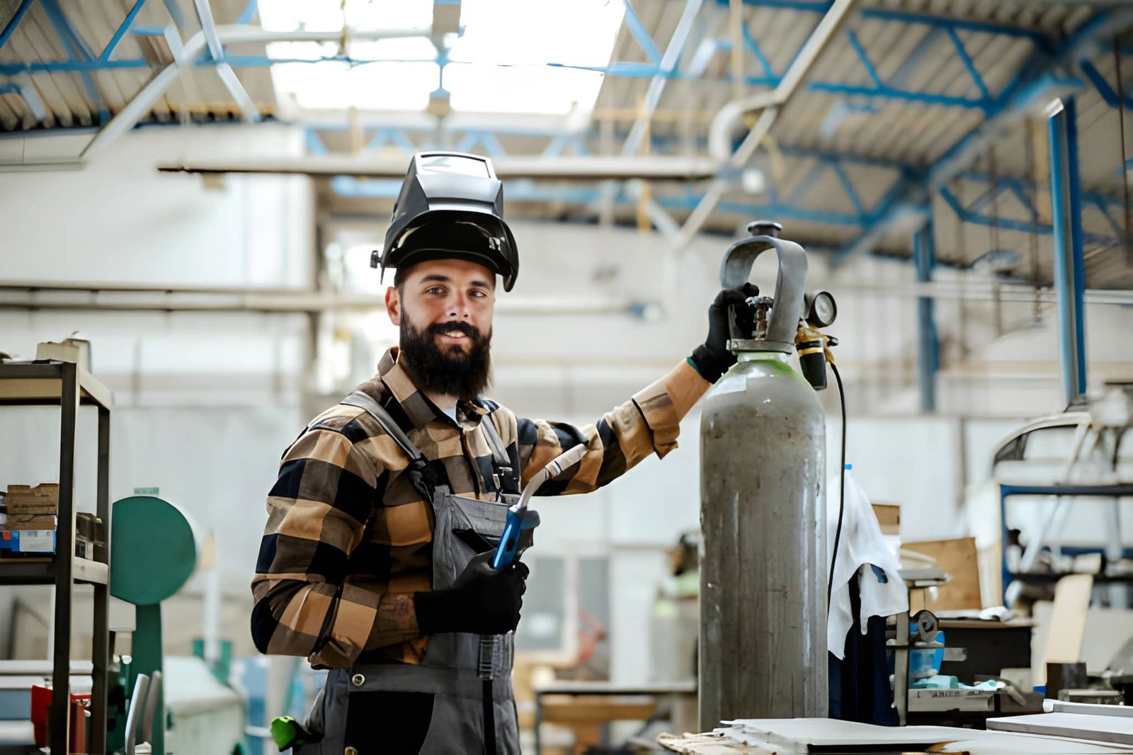 Fabrication trade worker welding metal components in a workshop